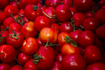 Lots of ripe, juicy tomatoes at the market. Natural nutrition and vitamins. Close-up.