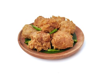 Gehu or Indonesian food made from fried tofu filled with bean sprouts and spices on wooden plate isolated on white background. High angle view 