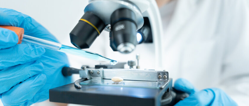 Scientist analyze biochemical samples in advanced scientific laboratory. Medical professional use microscope look microbiological developmental of viral. Biotechnology research in science lab.