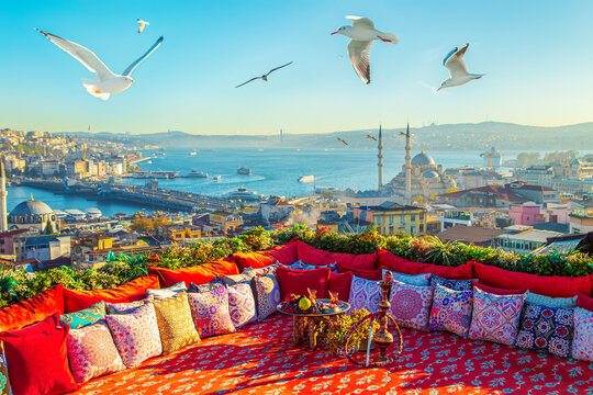 Magnificent panoramic views of Istanbul from the rooftop with a traditional Turkish carpet, pillows, hookah and a fruit table.