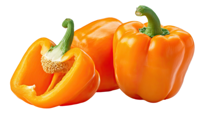 Vibrant orange bell peppers, one sliced open, on black
