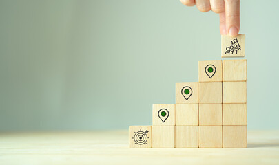 Business progress and project roadmap concept.  Wooden blocks with the icon of  steps in a project or strategic planning process. Waypoint icons and ends with goal achievement.