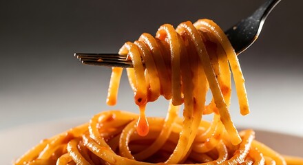 Delicious spaghetti strands twirled on a fork with dripping flavorful tomato sauce in macro shot
