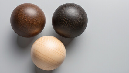 Dark and white wooden spheres on gray background 