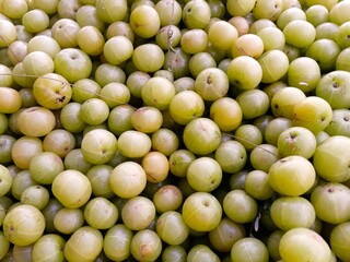 Fresh Amla Indian gross berries heap at market place