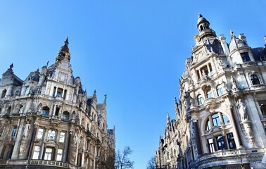 Antwerp historic buildings facade architecture details against clear blue sky in Belgian old city street