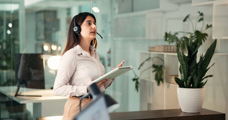 Headset, talking and business woman on tablet for financial advice, planning and insurance deal at night. Late, corporate and person on digital tech for negotiation, networking and finance consulting