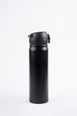 A black drinking bottle is placed on a white background, creating a clean and striking contrast