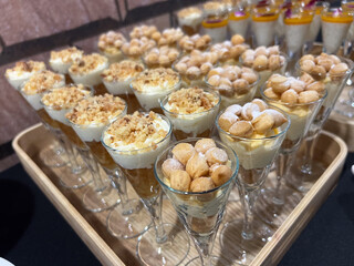Assorted mini desserts in glass cups at catered event