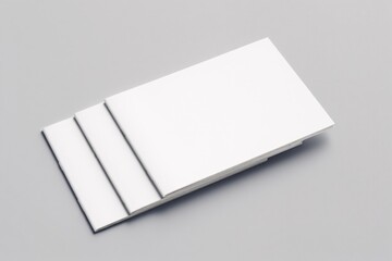 Clean white business cards stacked on a gray surface
