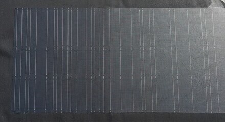 Detailed shot of a textured glass surface, highlighting the intricate grid pattern and subtle reflections creating a modern and minimalist aesthetic