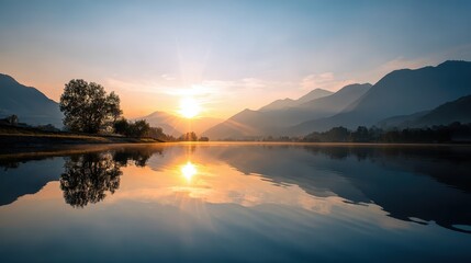Fototapeta premium Sunrise over tranquil lake reflecting mountains and trees at dawn in a serene landscape setting
