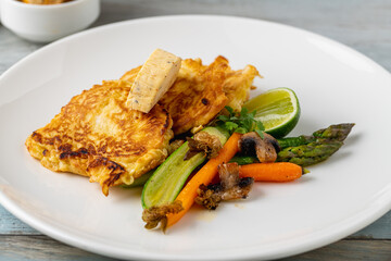 Close-up of vegetable omelette served with asparagus and carrots