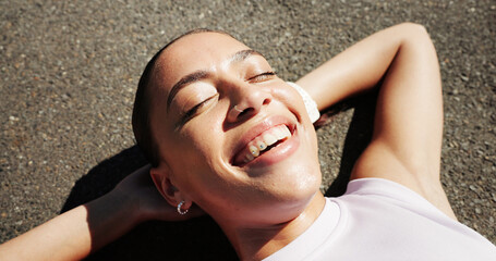 Happy, fitness and above of woman in road for rest, recovery and relax for exercise, workout and training. Sports, outdoor and person with break in town for health, wellness and smile for cardio