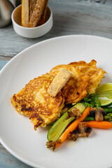 Close-up of vegetable omelette served with asparagus and carrots