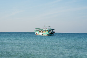 Aerial drone above boat cruising through Andaman Sea paradise island. 