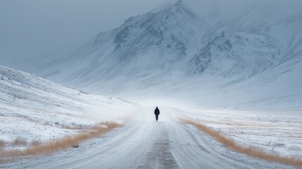 Lone man walking along snowy road toward distant mountain in quiet winter landscape peaceful solitary traveler on white forest path serene nature adventure background