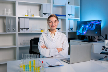 Portrait of Caucasian female scientist in white lab coat in laboratory. 