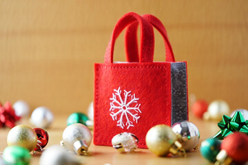 Red and golden Christmas gift boxes with baubles, ribbon, and bow decoration for the holiday season celebration