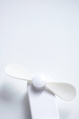 Mini electric fan with handle isolated on white background