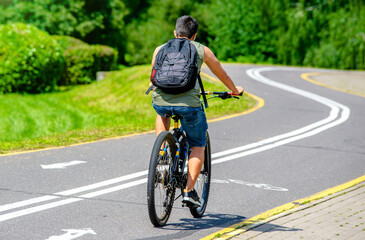 Fototapeta premium Cyclist ride on the bike path in the city Park 