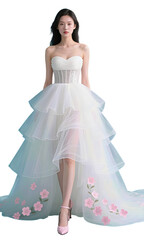 Fototapeta premium Elegant Asian woman in a white tiered wedding gown with pink floral details