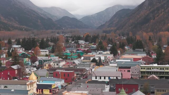 Aerial telephoto shot flying over colorful 19th century buildings in Skagway during the fall season in Southeast Alaska. 4K