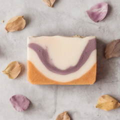 A bar of soap with marbled pattern. Creative soap surrounded petals 