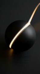 Obraz premium Abstract black sphere with glowing textured light strip on dark background