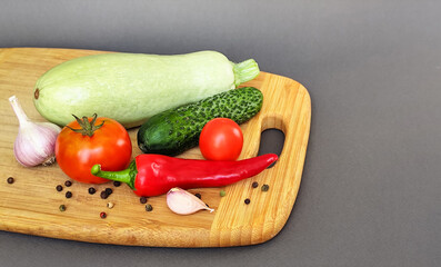 Composition of fresh vegetables on a wooden surface