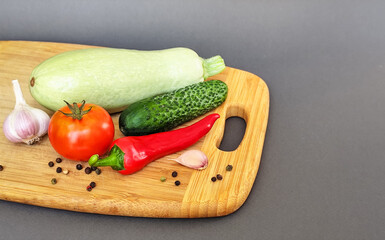 Composition of fresh vegetables on a wooden surface
