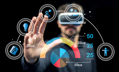 Person Using Virtual Reality Technology with Interactive Data Visualization and Digital Icons for Innovative Experience and Engagement in a Dark Environment