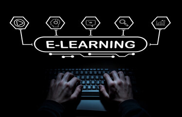 Hands Typing on Keyboard with E-Learning Concept Overlaid in Dark Environment for Online Education and Digital Learning Promotion