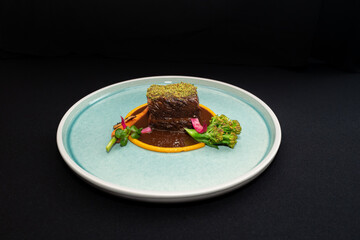 Gourmet dish presentation with succulent meat and fresh vegetables, offering an enticing culinary experience