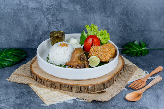 Duck chilli green, or bebek cabe hijau, is a flavorful Indonesian dish featuring tender duck simmered and stir-fried with a vibrant green chili sauce, shallots, garlic, and spices&mdash;served with rice, te