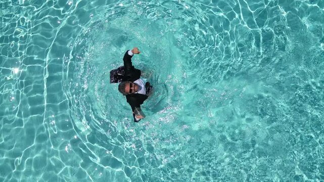 Excited businessman in pool water. Summer business. Business success. Freelance work, distance online work. Summer excited business man in suit in sea water. Funny summer business.