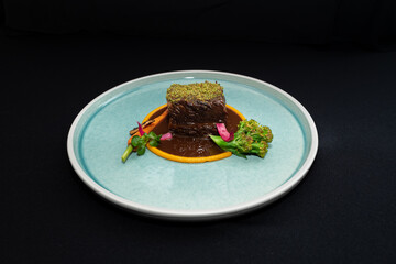 A visually appealing plate of culinary art, showcasing a meticulously arranged meal with a dark backdrop. The dish, is a testament to the chef's expertise and creative vision
