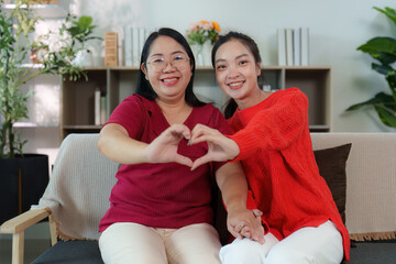 Heartfelt connection. Two women forming a heart shape with their hands.