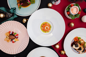 Exquisite culinary art on a festive table setting, showcasing a diverse array of gourmet dishes and elegant tableware. The scene exudes an atmosphere of fine dining and celebratory ambiance