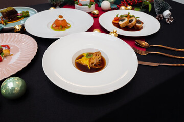 Elegant plates of gourmet food arranged on a table, showcasing culinary artistry