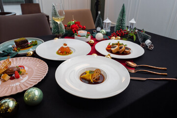 Festive holiday feast meticulously arranged on a table, including variety of dishes and seasonal decorations.