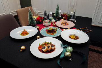 A festive and delicious holiday table setting, perfect for a special gathering, filled with beautifully plated cuisine. The atmosphere exudes warmth and togetherness. 