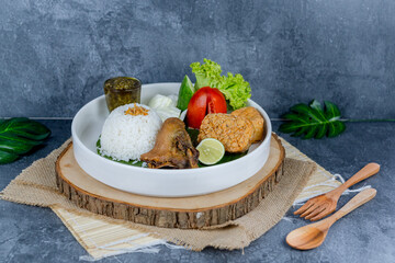 Duck chilli green, or bebek cabe hijau, is a flavorful Indonesian dish featuring tender duck simmered and stir-fried with a vibrant green chili sauce, shallots, garlic, and spices—served with rice, te