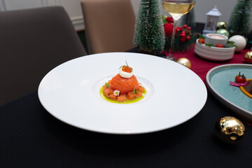 A beautifully plated gourmet dish. The dish is presented on a white plate, the scene evokes a sense of culinary elegance