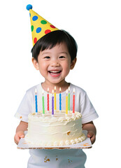 Smiling young child holding birthday cake with lit candles