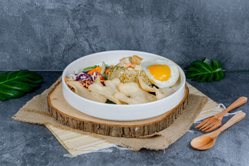 Seafood fried rice features savory stir-fried rice with fresh shrimp, squid, and veggies, topped with a sunny-side-up egg and crackers. Vibrant, flavorful, and satisfying for any meal.