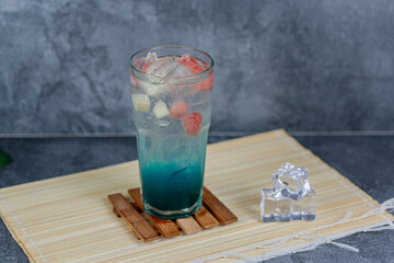 Refreshing fruit punch with vibrant blue hues, sparkling soda, and mixed fruit cubes. Served chilled, this drink blends tropical flair and fruity sweetness for any occasion.