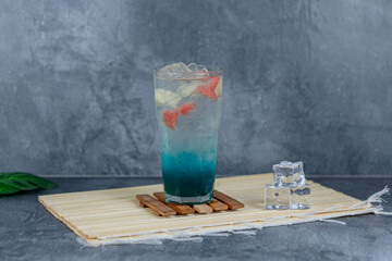 Refreshing fruit punch with vibrant blue hues, sparkling soda, and mixed fruit cubes. Served chilled, this drink blends tropical flair and fruity sweetness for any occasion.
