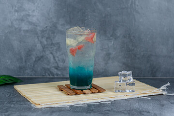Refreshing fruit punch with vibrant blue hues, sparkling soda, and mixed fruit cubes. Served chilled, this drink blends tropical flair and fruity sweetness for any occasion.