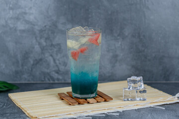 Refreshing fruit punch with vibrant blue hues, sparkling soda, and mixed fruit cubes. Served chilled, this drink blends tropical flair and fruity sweetness for any occasion.